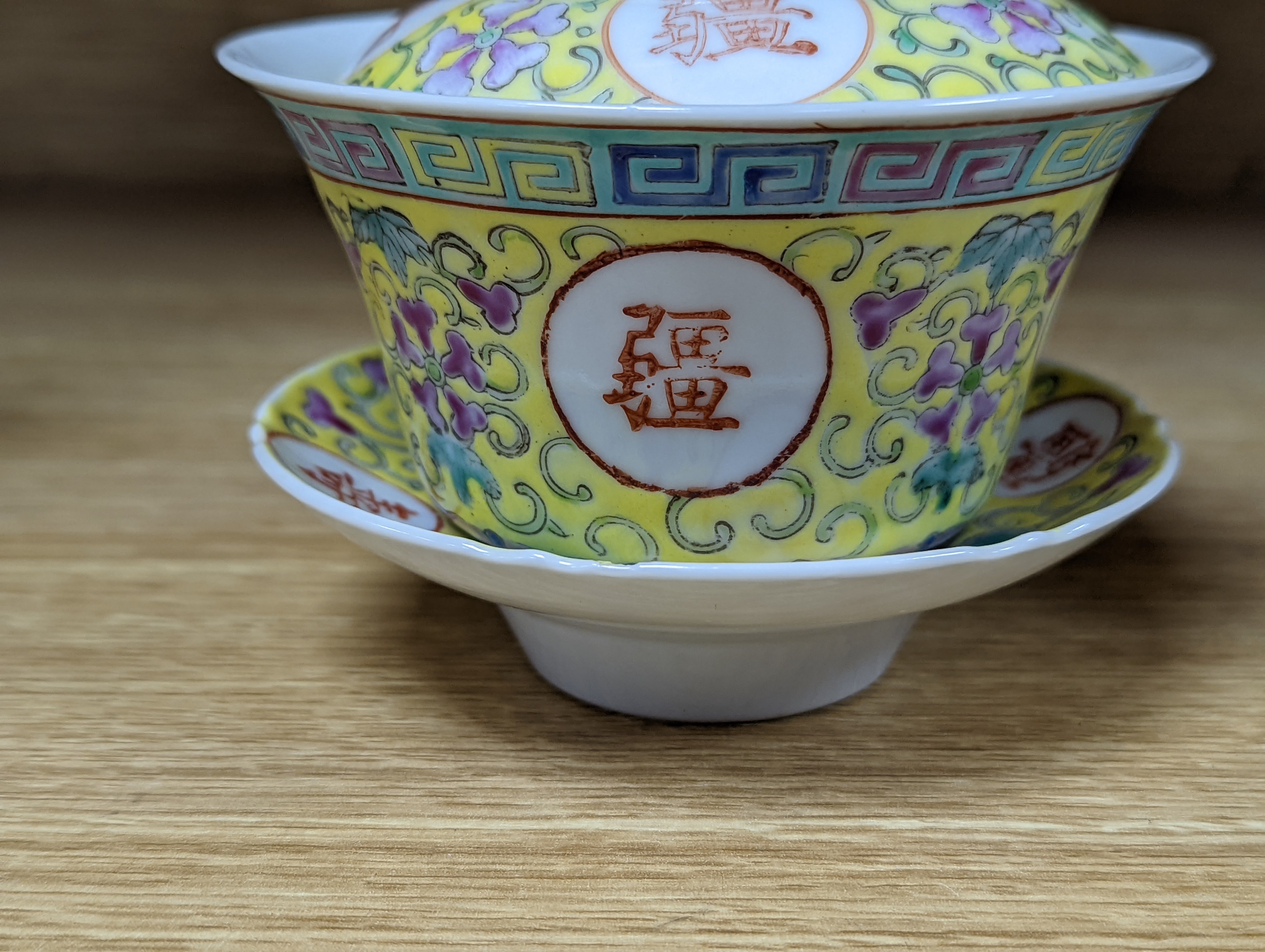 A pair of Chinese enamelled porcelain rice bowls, covers and stands and an odd bowl